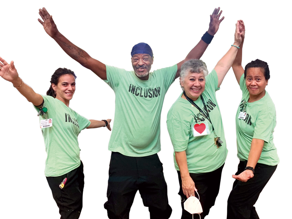 four HumanGood team members wearing "INCLUSION" t-shirts